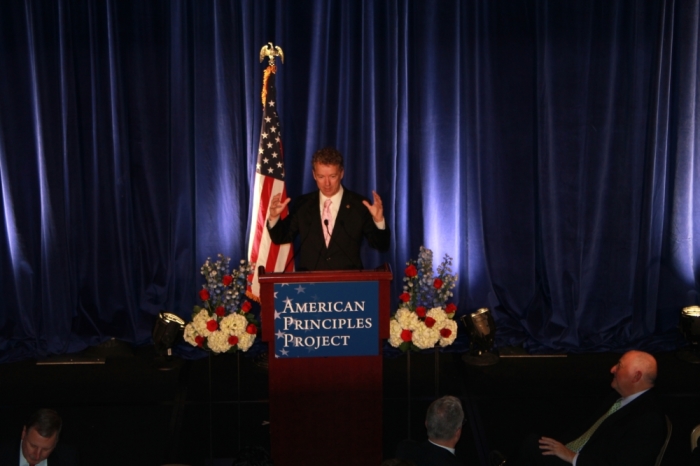 Kentucky Republican Senator Rand Paul demonstrates the size of government programs in a speech at The American Principles Project Gala in Washington, DC, Wednesday night.