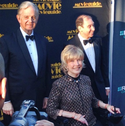Inspirational Christian speaker and quadriplegic Joni Eareckson Tada gets the red carpet treatment at the Movieguide Awards event along with co-writers of the song 'Alone Yet Not Alone,' Bruce Broughton (L) and Dennis Spiegal, Feb. 7, 2013.