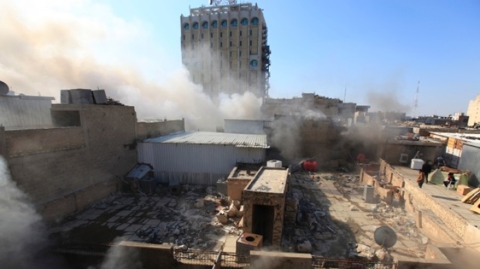 Smoke rises from the site of a bomb attack near Khullani Square in Baghdad February 5, 2014.