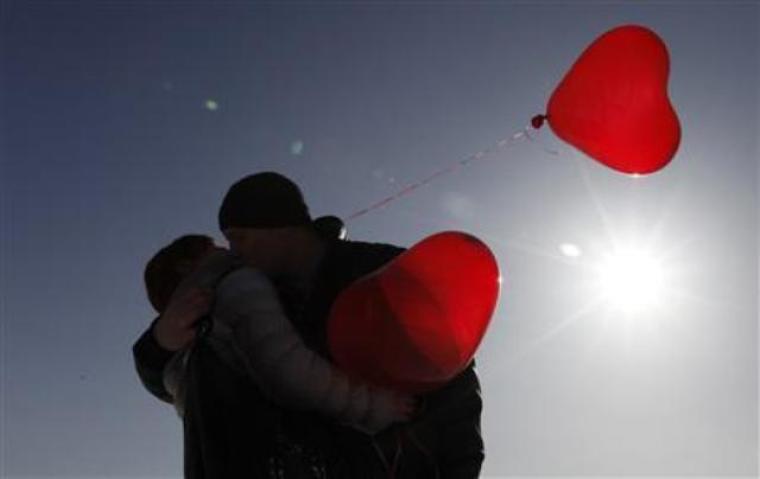 A couple kisses during a flashmob organised by a local television station on the eve of Valentine's Day in the southern Russian city of Stavropol, Feb. 13, 2012.