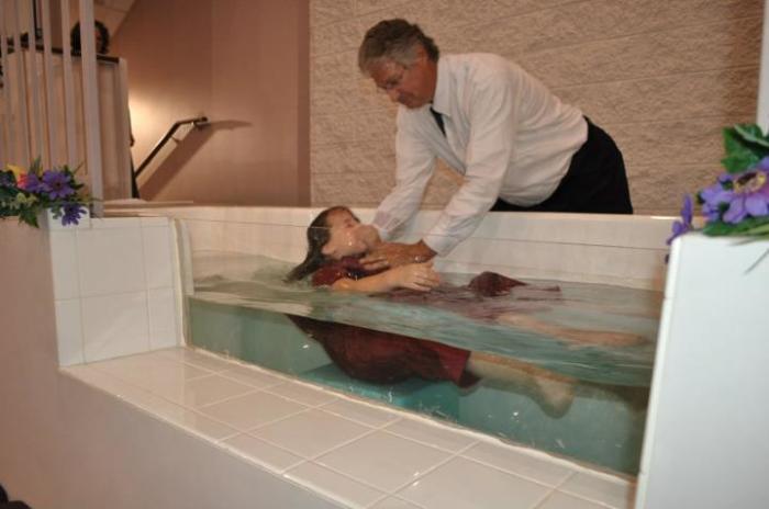 Senior pastor of the Hampshire Baptist Deaf Church in Silver Springs, Md., Terry Michael Buchholz performs a baptism.