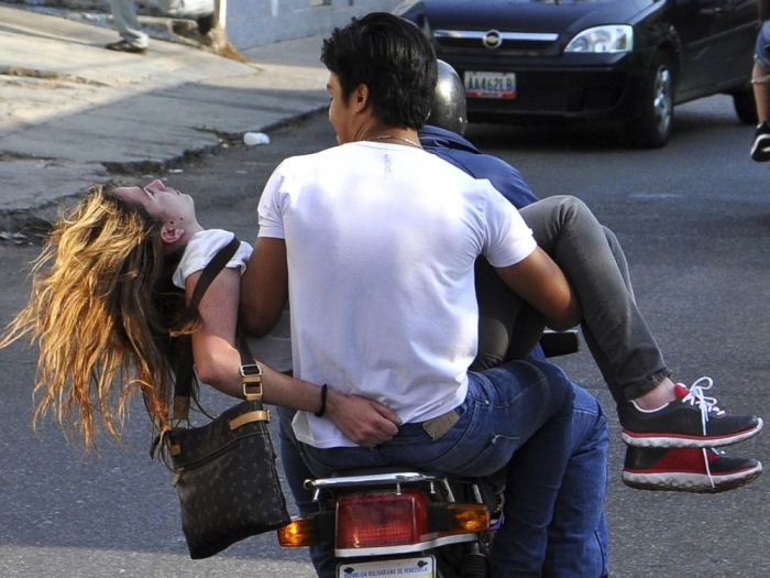 Witnesses say this photo shows Venezuelan beauty queen Genesis Carmona being evacuated from the scene of a protest on Tuesday. Carmona died after being shot, Feb. 19, 2013.