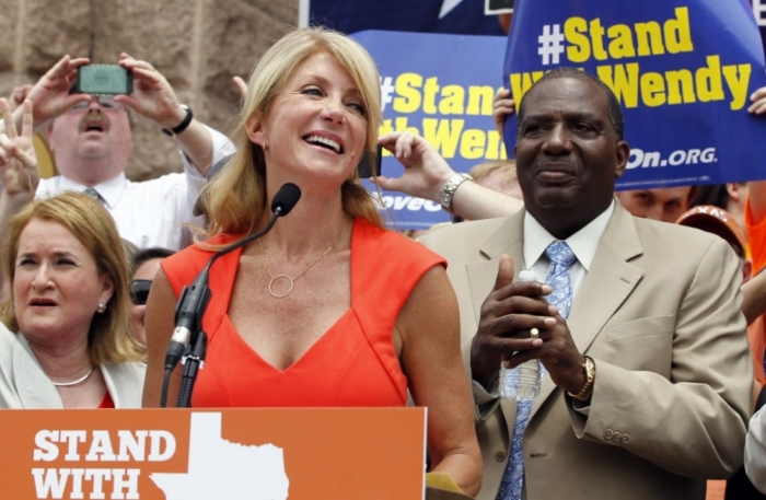 Democratic state Senator Wendy Davis (L) speaks at a protest before special session of the Legislature in Austin, Texas, July 1, 2013.
