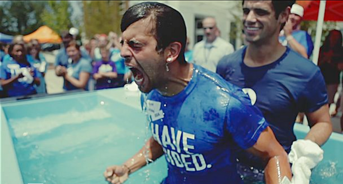 Pastor Steven Furtick (r) of Elevation Church in North Carolina in the baptismal pool with a new convert.