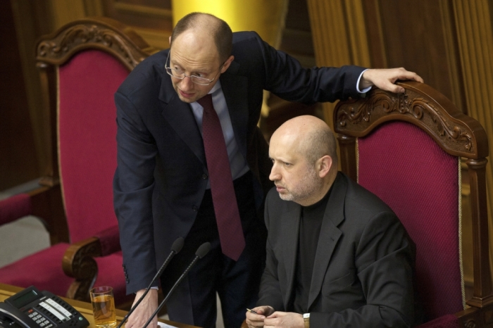 Newly-elected speaker of parliament Oleksander Turchinov speaks with opposition leader Arseny Yatsenyuk (L) during a parliament session in Kiev February 23, 2014. Turchinov, the speaker of the Ukrainian parliament and the closest confidante of freed opposition leader Yulia Tymoshenko, was temporarily handed the role of president on Sunday following the ouster of Viktor Yanukovich.