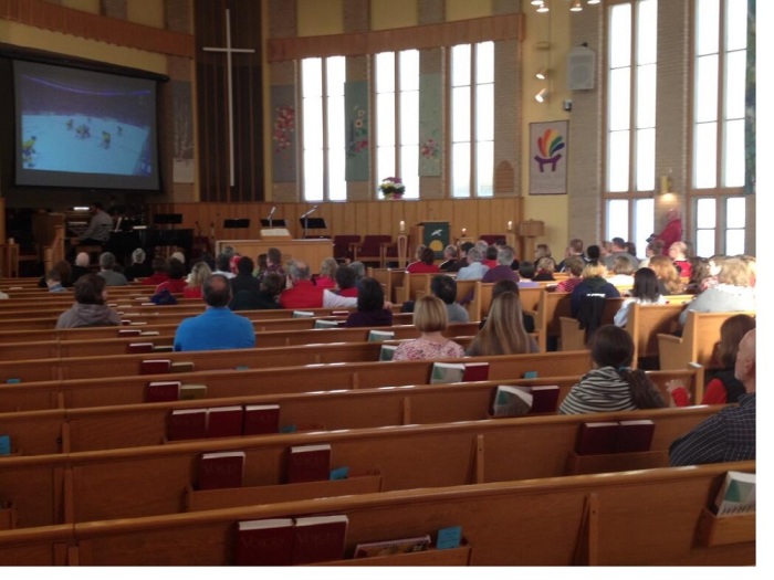 Church-goers watch the Canadian men's hockey team win the gold medal on February, 23, 2014.