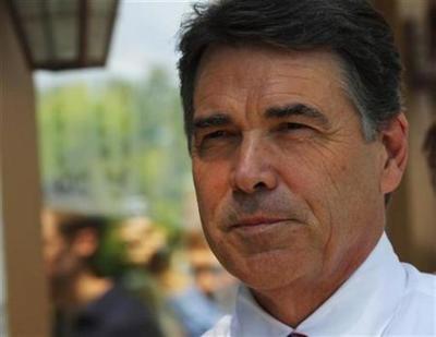 Republican presidential candidate Texas Governor Rick Perry leaves a campaign stop at Harvey's Bakery and Coffee Shop in Dover, N.H., Aug. 18, 2011.