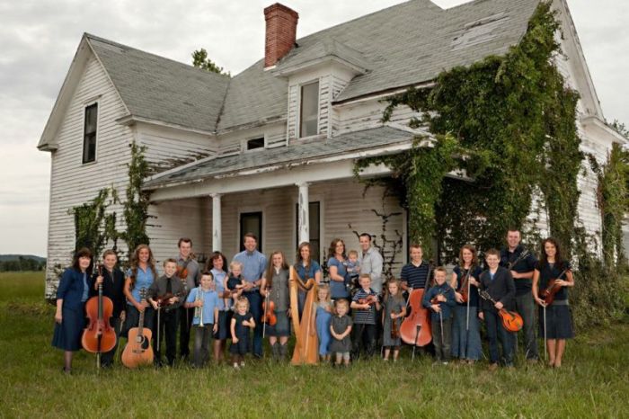 Jim Bob and Michelle Duggar with their 19 children, daughter-in-law, Anna, and their granddaughter, Mackynzie, pictured in front of an abandoned house holding their favorite instruments. The family's popular reality TV show that has been on for 10 years will be on TLC for it's next season on April 1, 2014.