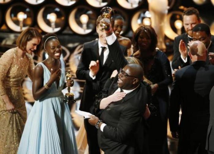 Director and producer Steve McQueen celebrates after accepting the Oscar for best picture with Lupita Nyong'o for 12 Years a Slave.
