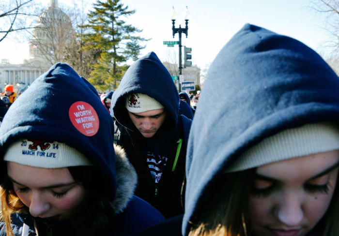 Pro-life demonstrators bow their heads in prayer in front of the U.S. Supreme Court during the annual March for Life in Washington, January 22, 2014.