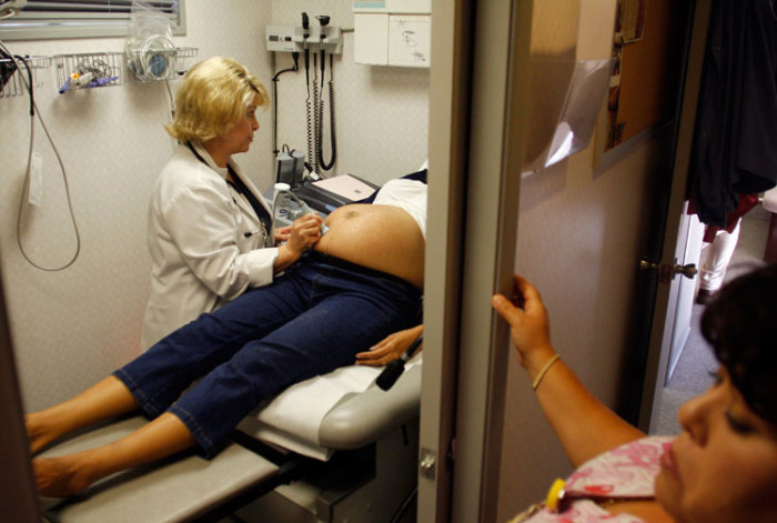 Guadalupe Hernandez receives an ultrasound by nurse practitioner Gail Brown during a prenatal exam at the Maternity Outreach Mobile in Phoenix, Arizona October 8, 2009.