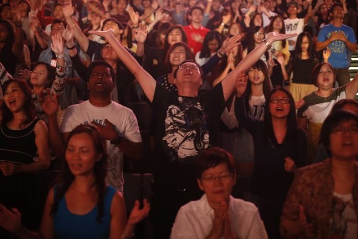 Worshippers attend a church service at the City Harvest Church in Singapore March 1, 2014.