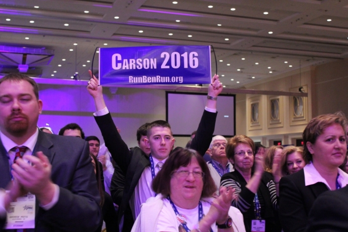 A CPAC attendee holds up a sign reading 'Carson 2016,' at the Conservative Political Action Conference in National Harbor, Md., March 8, 2014.