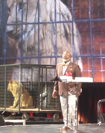 Bishop T.D. Jakes of The Potter's House megachurch preaches at the International Pastors & Leadership Conference in Orlando, Fla., March 7, 2014, with a lion on stage.