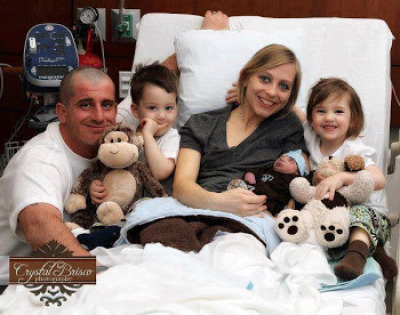 Heather Walker cradles her dying son, Grayson James, with husband, Patrick Walker, and two surviving children, Feb. 15, 2012.
