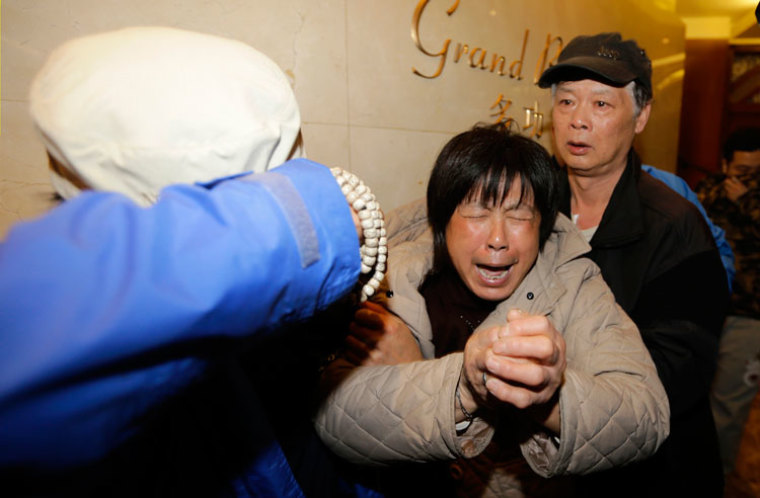 A family member of a passenger aboard Malaysia Airlines flight MH370 cries after watching a television broadcast of a news conference, at the Lido hotel in Beijing, March 24, 2014. Malaysian Prime Minister Najib Razak has told families of passengers of a missing Malaysian airliner that the plane ended its journey in the southern Indian Ocean, he said on Monday.
