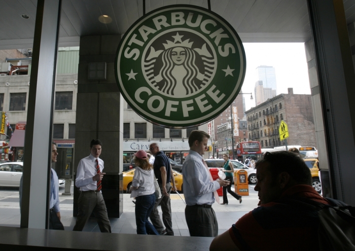 People walk past the Starbucks outlet on 47th and 8th Avenue in New York in this file photo.