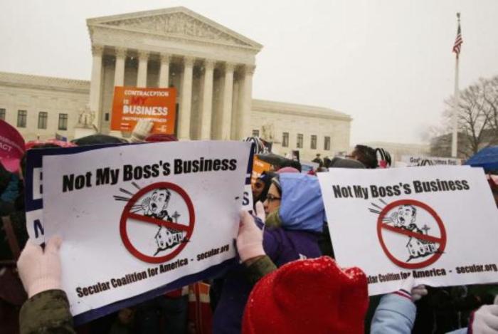 Protesters rally at the steps of the U.S. Supreme Court as arguments began on March 25, 2014, to challenge the Affordable Care Act's requirement that employers provide coverage for contraception and abortion-inducing drugs.