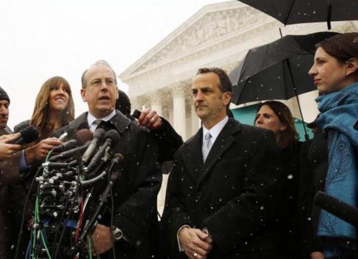 Attorney Paul Clement (2nd L) speaks to the press next to attorney Dave Cortman (3rd R) on the steps of the Supreme Court in Washington, March 25, 2014, after presenting arguments to challenge the Affordable Care Act's requirement that employers provide coverage for contraception as part of an employee's health care.