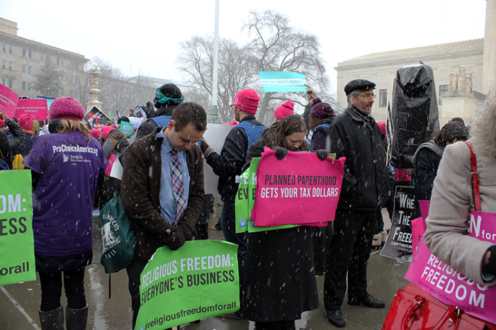 Protesters demonstrate outside the Supreme Court building during oral arguments on Hobby Lobby lawsuit on Tuesday, March 25, 2014.