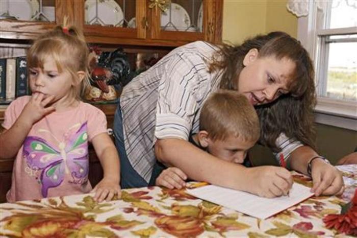 Christa Keagle works with her children Rebekah, 3, and Joshua Keagle, 6, during a homeschool assignment in St. Charles, Iowa, Sept. 30, 2011.