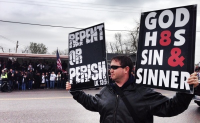 Westboro Baptist Church member Samuel Phelps Roper, the grandson of the-late Fred Phelps, stands outside Central Junior High in Moore, Okla., on April 6, 2014.