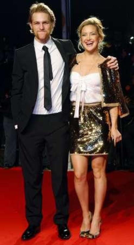 U.S. actress Kate Hudson arrives on the red carpet with her step-brother Wyatt Russell (L) during an event at Milan Fashion Week March 2, 2009. Dolce & Gabbana launched their debut makeup collection with a photo exhibition entitled "Extreme Beauty in Vogue".