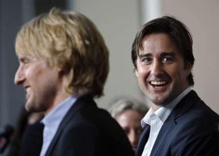 Co-director, writer and cast member Luke Wilson (R) smiles as his brother Owen (foreground) is interviewed at the premiere of 