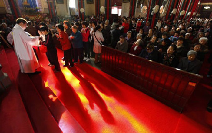 Christians receive communion at the state-controlled Xishiku Cathedral in Beijing.