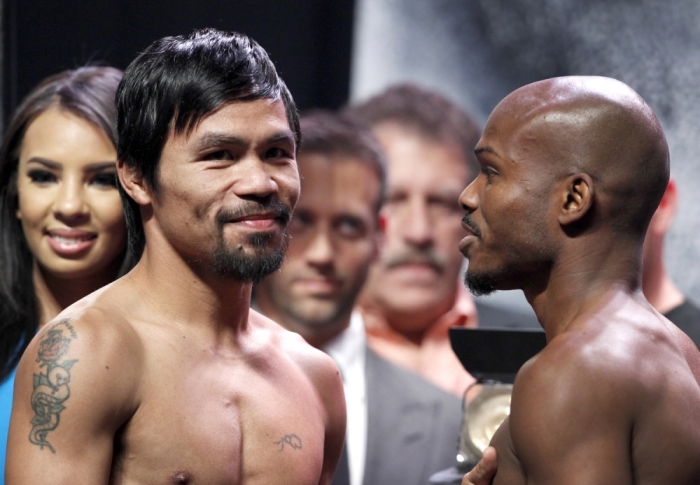 Boxer Manny Pacquiao (L) of the Philippines poses with undefeated WBO welterweight champion Timothy Bradley of the U.S. during an official weigh-in at the MGM Grand Garden Arena in Las Vegas, Nevada, April 11, 2014. Pacquiao will challenge Bradley at the arena on April 12, in a rematch of the June 2012 fight that Bradley won.