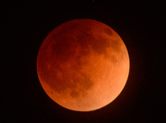 The moon is shown in eclipse from Los Angeles, California, April 15, 2014. The lunar eclipse on Tuesday will unfold over three hours when the moon begins moving into Earth's shadow. A little more than an hour later, the moon will be fully eclipsed and shrouded in an orange, red or brown glow.