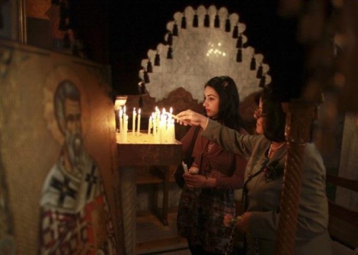 Palestinian Christians light candles during an Easter mass at the Saint Porfirios church in Gaza City April 8, 2012.