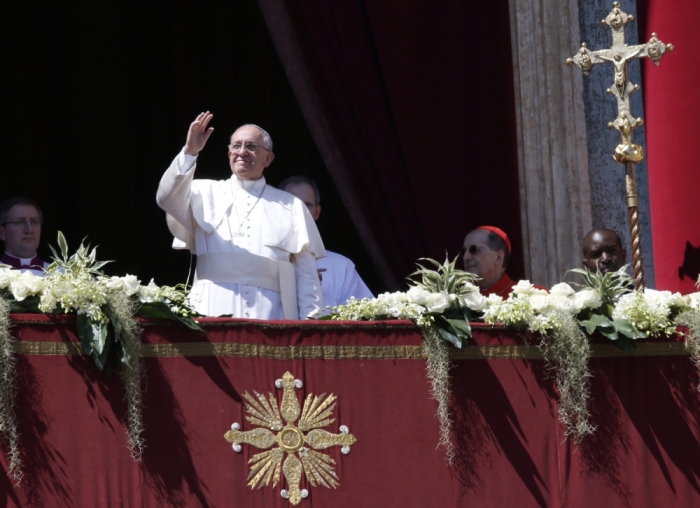 Pope Francis waves as he arrives to deliver the Urbi et Orbi (to the city and the world) benediction at the end of the Easter Mass in Saint Peter's Square at the Vatican April 20, 2014.