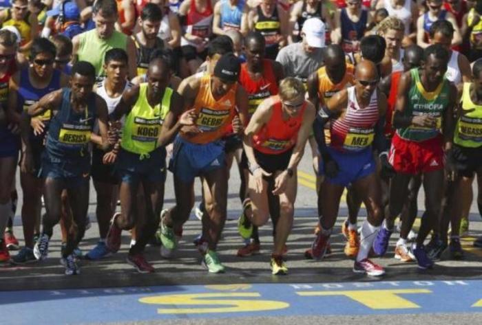 Athletes from the elite men's field, including 2013 winner Lelisa Desisa (L), start during the 118th running of the Boston Marathon in Hopkinton, Mass., on April 21, 2014.