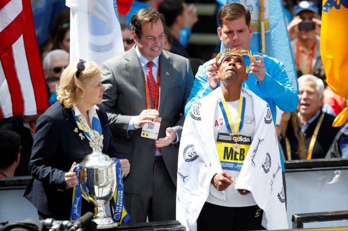 Boston mayor Marty Walsh places the laurel on the head of Meb Keflezighi (USA) after he won the men's division of the 2014 Boston Marathon.