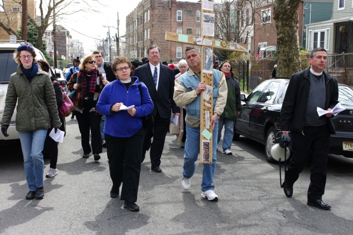 Jersey City churches hold a Stations of the Cross for sites of violent crime in the city. Cross-bearer is Carlos Hernandez, between Rector of Grace Church Van Vost the Rev. Laurie Jean Wurm (left) and the Rector of St. Paul's Church in Bergen the Rev. Tom Murphy.