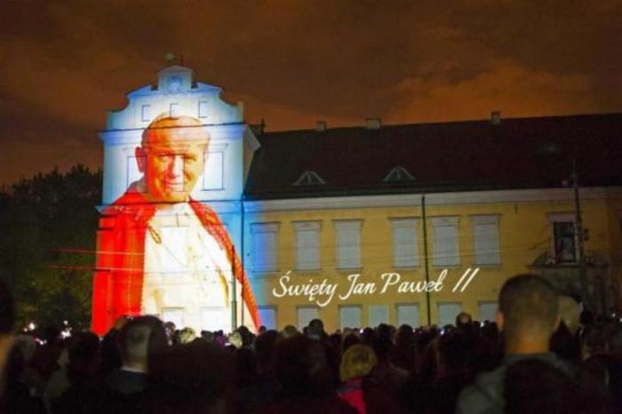 An image of Pope John Paul II is projected during a multimedia show a night before his canonization in Krakow, Poland, April 26, 2014.