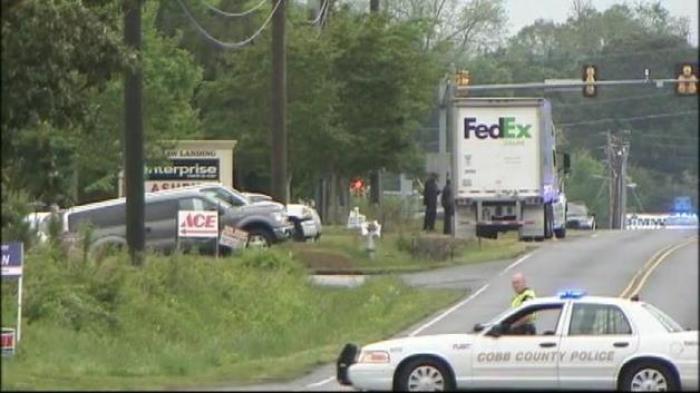 Police vehicles on the scene of a shooting at a FedEx in Kennesaw, Ga. Tuesday morning, April 29, 2014.