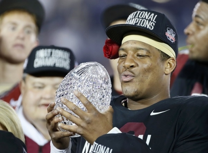 Florida Seminoles quarterback Jameis Winston holds the championship trophy after they defeated the Auburn Tigers to win the BCS Championship football game in Pasadena, California January 6, 2014.