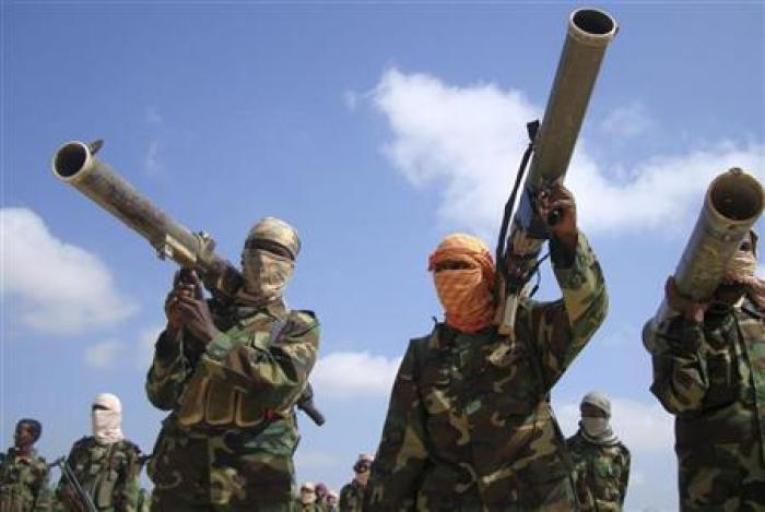Members of the hardline al Shabaab Islamist rebel group hold their weapons in Somalia's capital Mogadishu, Jan. 1, 2010.