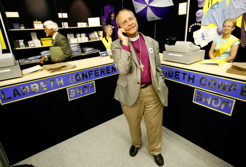 Bishop Gene Robinson from the U.S. the only openly gay bishop in the Anglican church speaks on his phone as he tours the "market place" a collection of stalls run by Christian organizations on the fringes of the Lambeth Conference in Cantebury, southern England July 21, 2008. Robinson has been barred from attending the Lambeth conference, a meeting of bishops of the Anglican faith held once every 10 years, but is taking part in activities on the sidelines of the meeting.