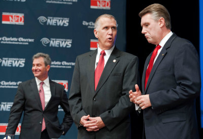 Thom Tillis (C) talks with Mark Harris, (R) before a debate between the four top-polling Republican candidates in North Carolina for the U.S. Senate, at Davidson College in Davidson, North Carolina April 22, 2014. Also shown is candidate Greg Brannon (L). Picture taken April 22, 2014.