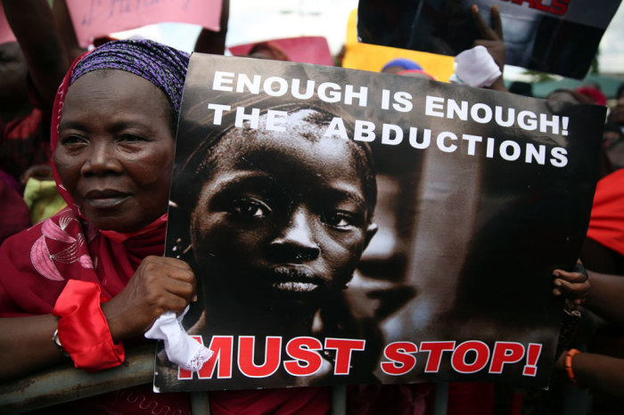 A woman holds a sign during a protest demanding the release of abducted secondary school girls from the remote village of Chibok, in Lagos May 5, 2014.