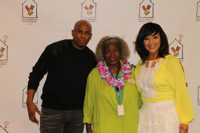 Gospel music stars Erica Campbell and Anthony Brown pose with veteran volunteer Irma Young at Gatewood House in Atlanta