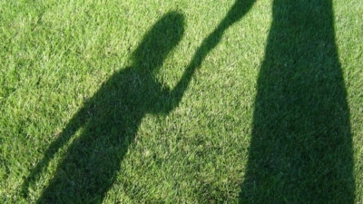 A mother and child captured in a shadow.