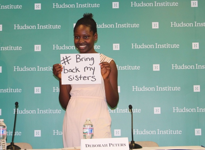 Deborah Peters, a Nigerian teenage girl whose father and brother were murdered by Boko Haram in 2011, holds a sign in support of the effort to rescue 300 Nigerian schoolgirls who were abducted by the terrorist organization in 2014. She was part of a panel on her experience held at the Hudson Institute in Washington, DC on Tuesday, May 13, 2014.