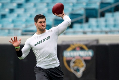 Now former New York Jets backup quarterback Tim Tebow warms up before the start of their NFL football game against the Jacksonville Jaguars in Jacksonville, Florida December 9, 2012.