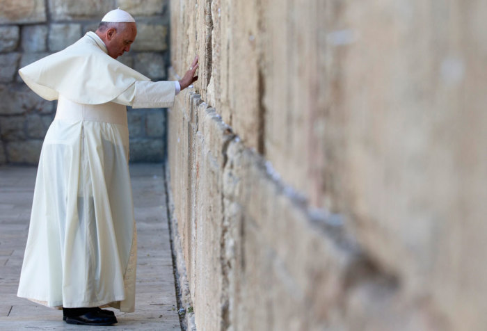 Pope Francis touches the stones of the Western Wall, Judaism's holiest prayer site, in Jerusalem's Old City May 26, 2014. Francis completes a tour of the Holy Land on Monday, paying homage to Jews killed in the Nazi Holocaust and looking to affirm Christian rights at a disputed place of worship in Jerusalem.