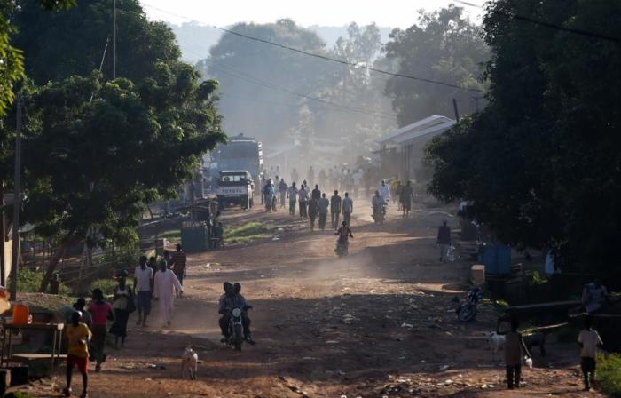 People walk along a main street in the Central African Republic capital of Bangui where at least 30 people were killed in an attack by Muslim extremists on a Christian church at a refugee camp on May 28, 2014.