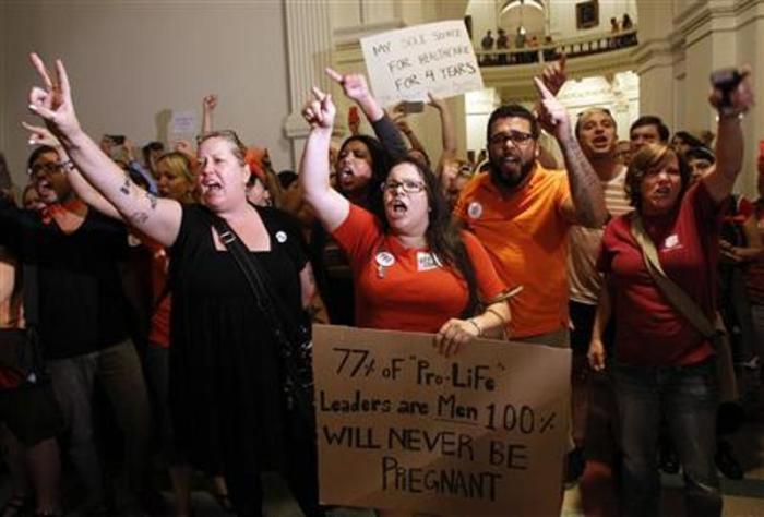 Abortion activists demonstrate outside the floor of the House after the HB2 bill that requires abortion facilities to meet basic health and safety standards passed in Austin, Texas, July 9, 2013.